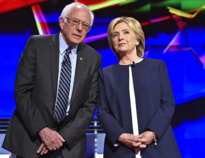 Democratic presidential candidates  Sen. Bernie Sanders, of Vermont, left, and Hillary Rodham Clinton talk before the CNN Democratic presidential debate Tuesday, Oct. 13, 2015, in Las Vegas. (AP Photo/David Becker)